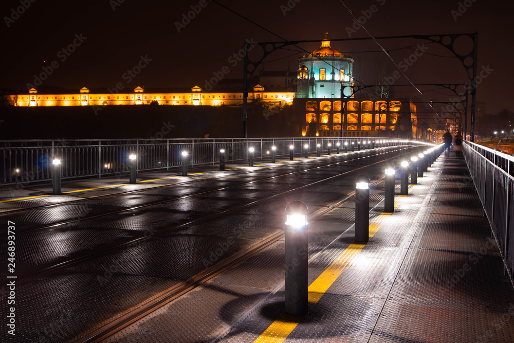 Dom Luis I Bridge at night with Serra do Pilar Monastery in the background, Porto, Portugal. The bridge is a popular tourist spot as it offers an amazing view over the city. 