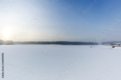 Winter landscape with snow field and road © wolf139