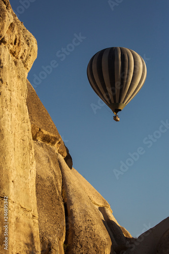 Colorful hot air balloon flying over a beatiful blue sky in background