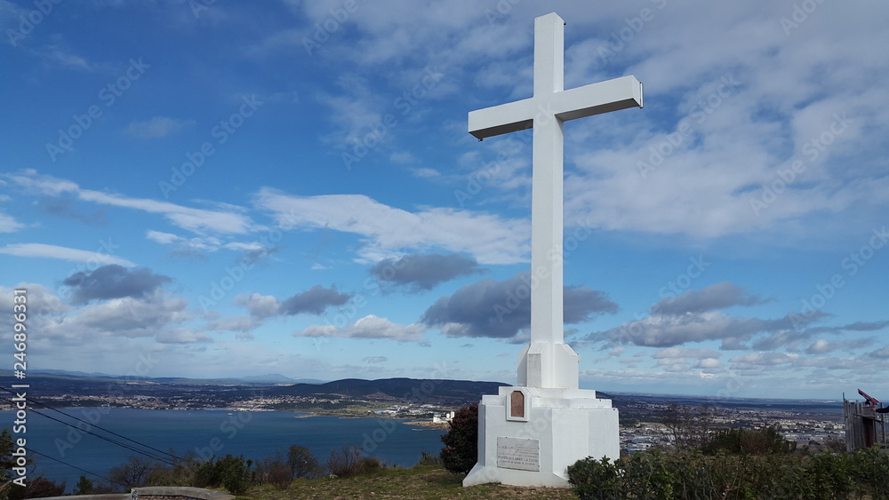 View from a high mountain on the city, with a large cross monument