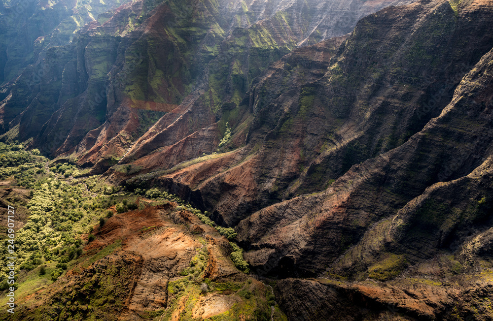 Aerial view of Waimea Canyon and landscape of hawaiian island of Kauai from helicopter flight