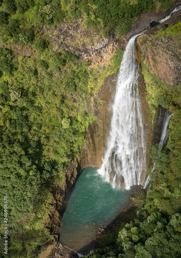 Obraz premium Aerial view of Manawaiopuna Falls and landscape of hawaiian island of Kauai from helicopter flight
