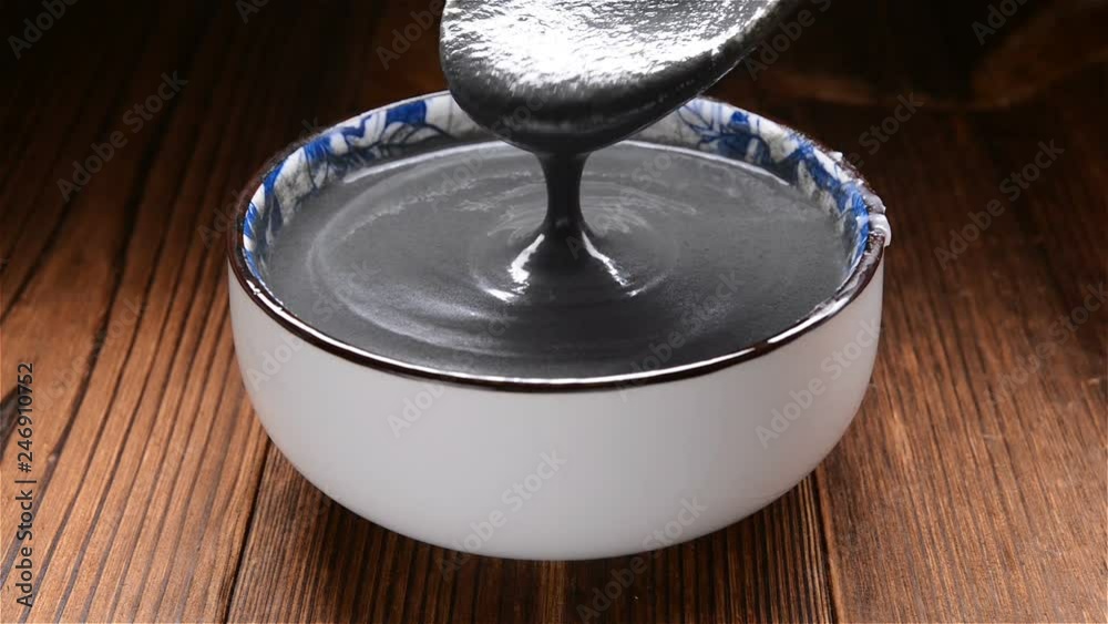 spoon taking out black sesame paste