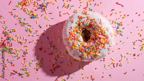 Donuts with icing on a pastel pink background. Sweet donuts. Flat lay. Banner