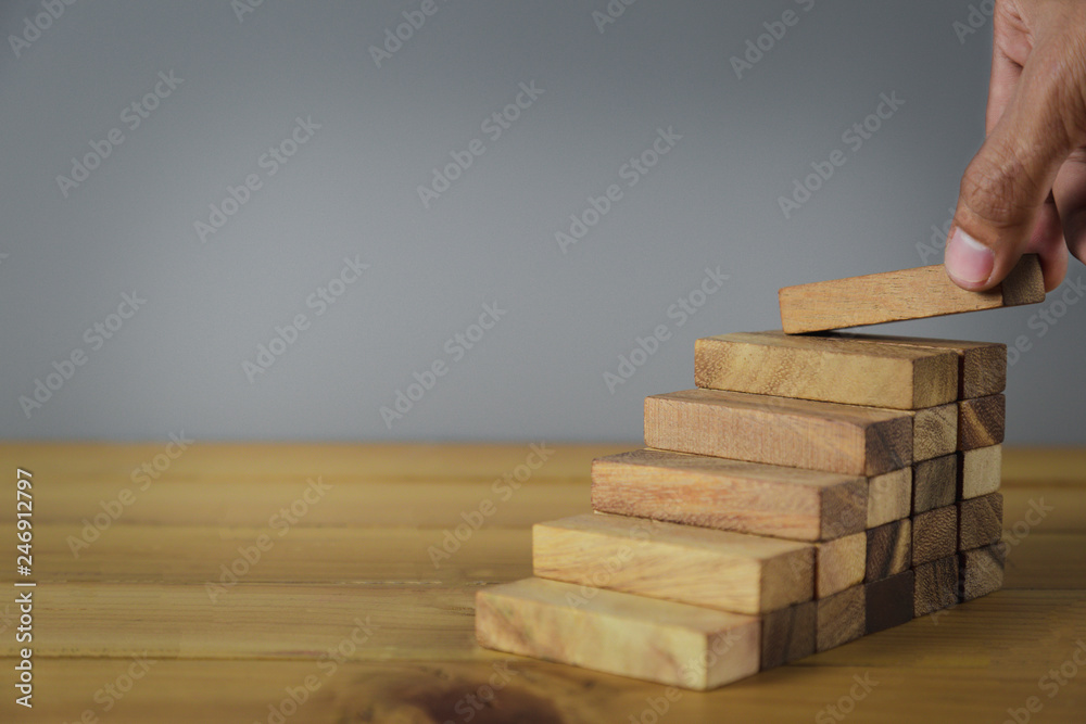 Closer up hands of businessmen,stacking wooden blocks into steps,Concept of business growth success - image Closer up hands of businessmen,stacking wooden blocks into steps,Concept of business growth success - image