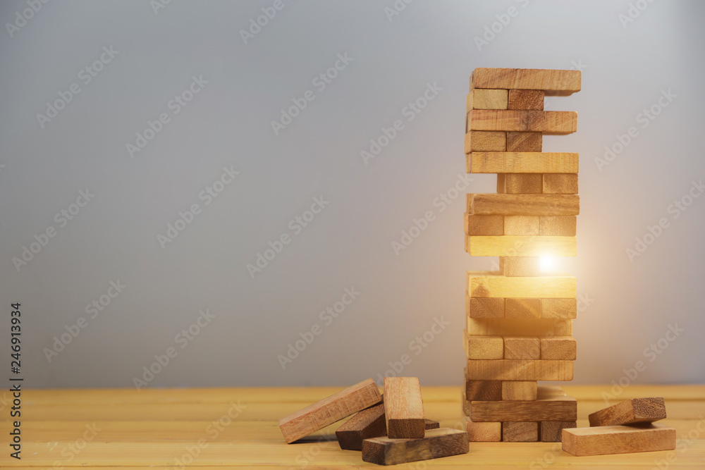Pulling out or placing wood block on the tower, plan and strategy in business.for background - Image Pulling out or placing wood block on the tower, plan and strategy in business.for background - Image