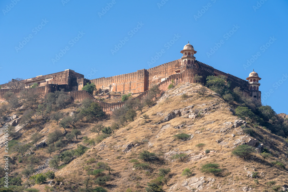The long wall on the mountain of Amber fort in historical city of Amer, Jaipur, Rajasthan, India