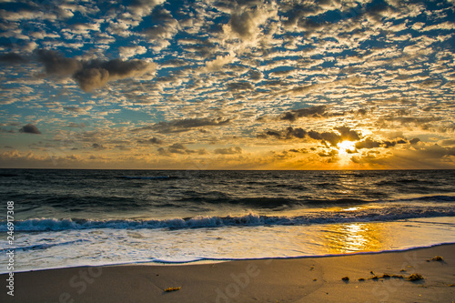Cloudscape as the sun's beams spread over the horizon of a Florida Beach