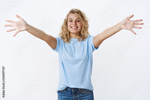 Come quickly hug. Portrait of friendly and welcoming charming charismatic blonde with blue eyes spread arms in cuddle smiling broadly, reaching camera over white background