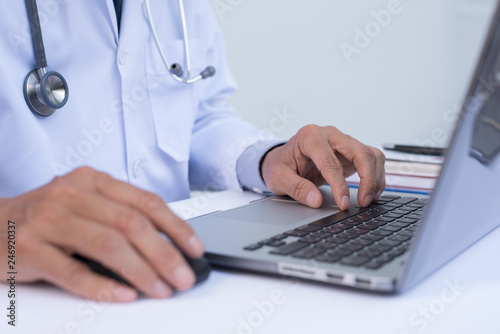 Doctor working on laptop computer