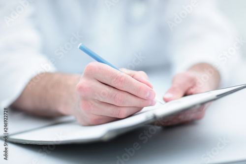 doctor writing out the prescription.close-up