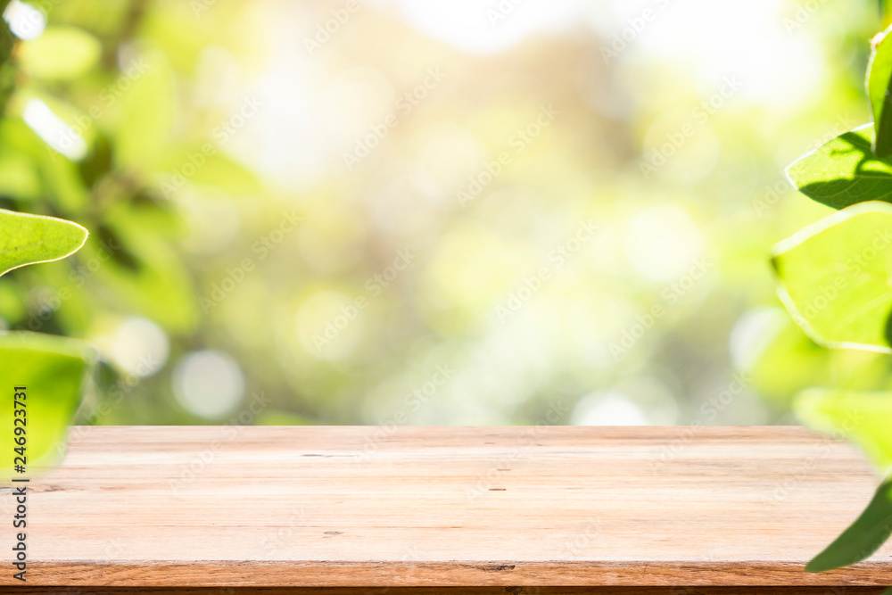 Wooden table with blur background of green bokeh. Wooden table with blur background of green bokeh.