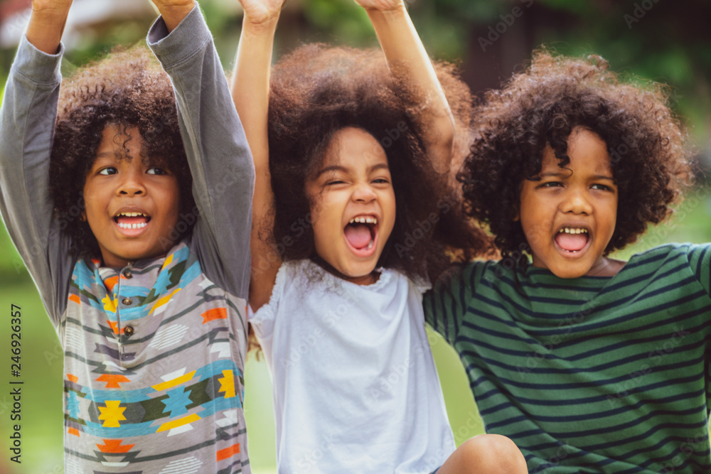 Happy African American boy and girl kids group playing in the ...