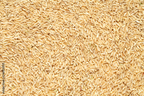 Organic brown rice texture background, top view.