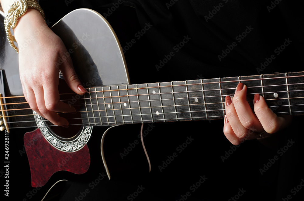 Female hands playing guitar