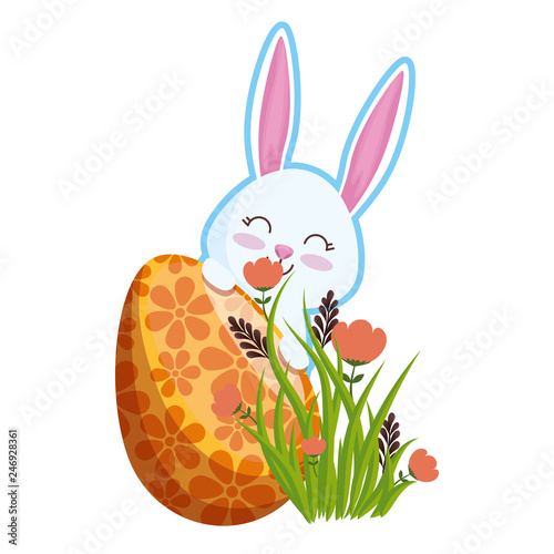 cute rabbit with easter egg painted in the garden