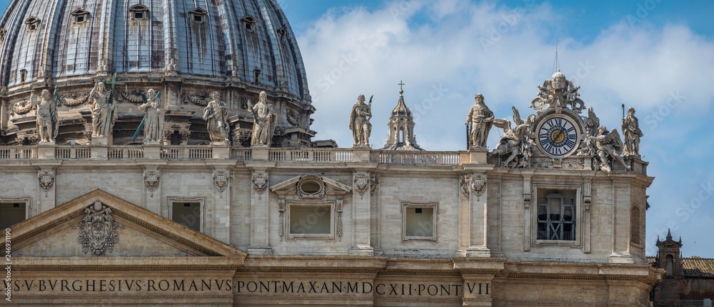 panoramic front view on Dome of St. Peter's Basilica with statues of apostles chapel with bell and old clock in Vatican City, Italy panoramic front view on Dome of St. Peter's Basilica with statues of apostles chapel with bell and old clock in Vatican City, Italy