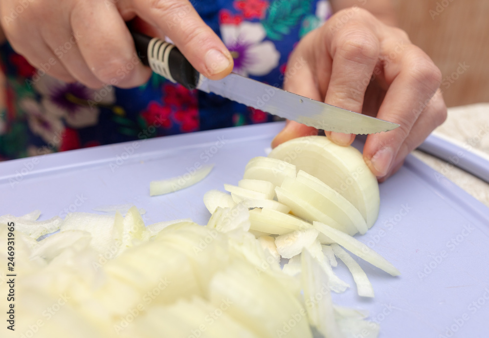 Woman cuts a bow with a knife Woman cuts a bow with a knife