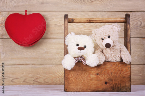 two teddy bears in the box with heart