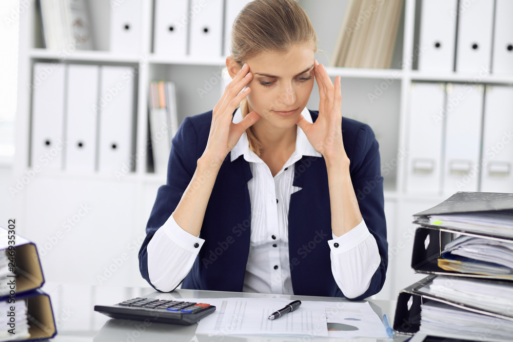 Tired business woman or female accountant with bills and paper folders in office Tired business woman or female accountant with bills and paper folders in office