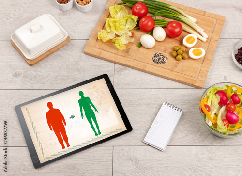 Arrangement of healthy Ingredients with a tablet. Dieting concept