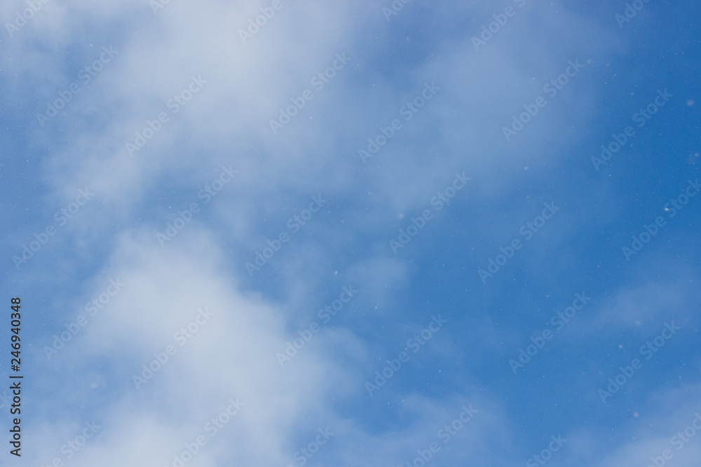 Blue sky. Blue sky with light clouds. From the blue sky it is snowing. Winter bright blue sky Blue sky. Blue sky with light clouds. From the blue sky it is snowing. Winter bright blue sky
