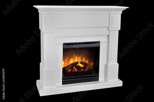 White wooden fireplace with roaring flames  classic elegant design. Isolated on black background  clipping path included. Fireplace as a piece of furniture