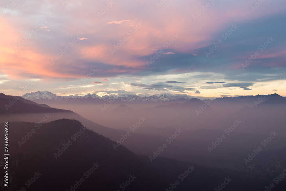 Alpine chain with Monte Rosa, colorful sunset with mist, Italy