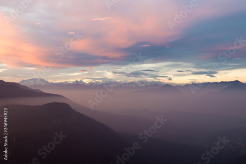 Alpine chain with Monte Rosa, colorful sunset with mist, Italy