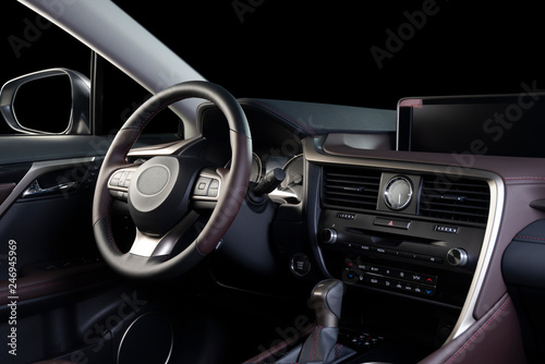 Car interior luxury. Beige comfortable seats, steering wheel, dashboard, climate control, speedometer, display, wood decoration, isolated on black, clipping path included © gargantiopa