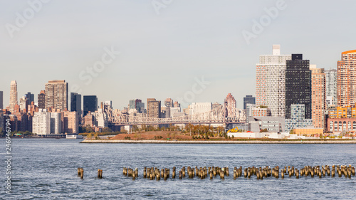 The view across the East River towards Hunter's Point South in Long Island City, New York City.  Roosevelt Island and Queensboro Bridge passing over the island can also be seen.