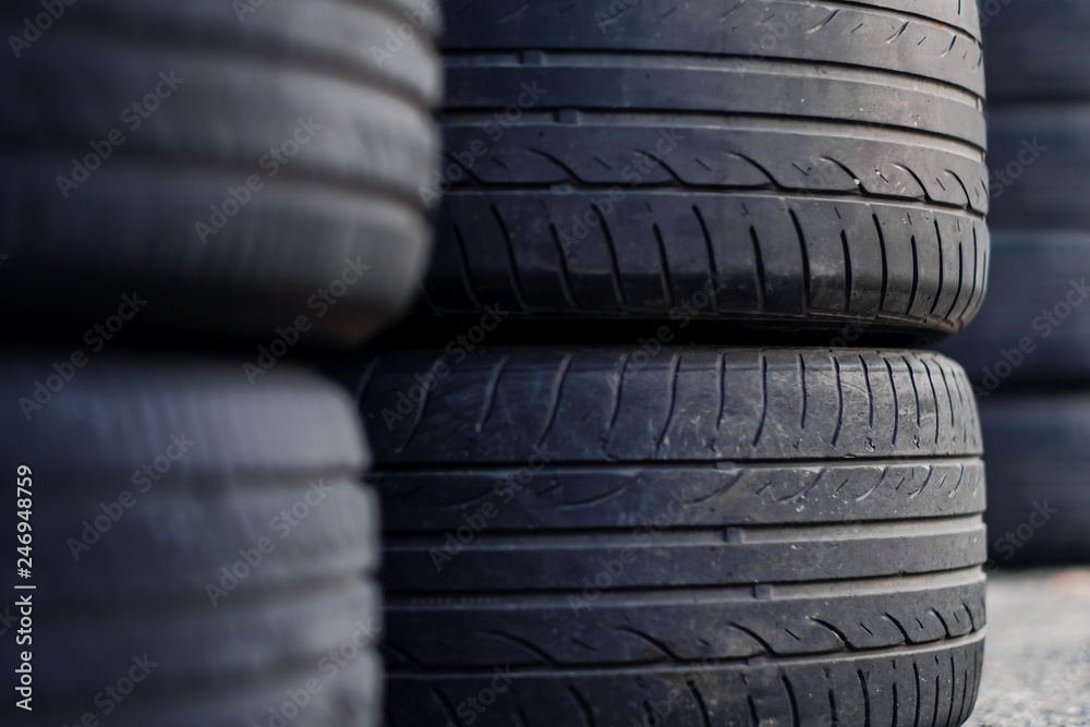 Closeup of Old Tire in the Garage. Selective Focus. Time to Change a New one Closeup of Old Tire in the Garage. Selective Focus. Time to Change a New one