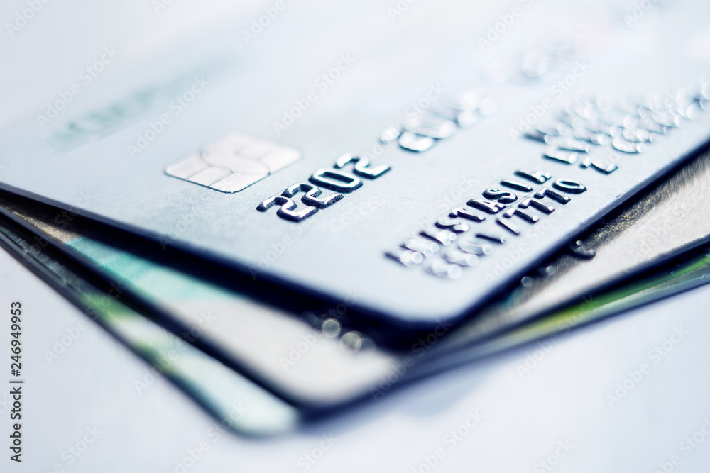 Debit bank cards on a light background. Credit cards stacked on light background