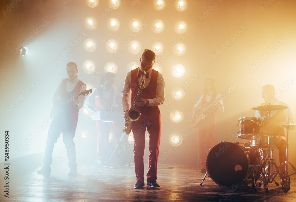Naklejka premium full length photo. important event . instrumentalist playing the guitar. tradition. culture concept