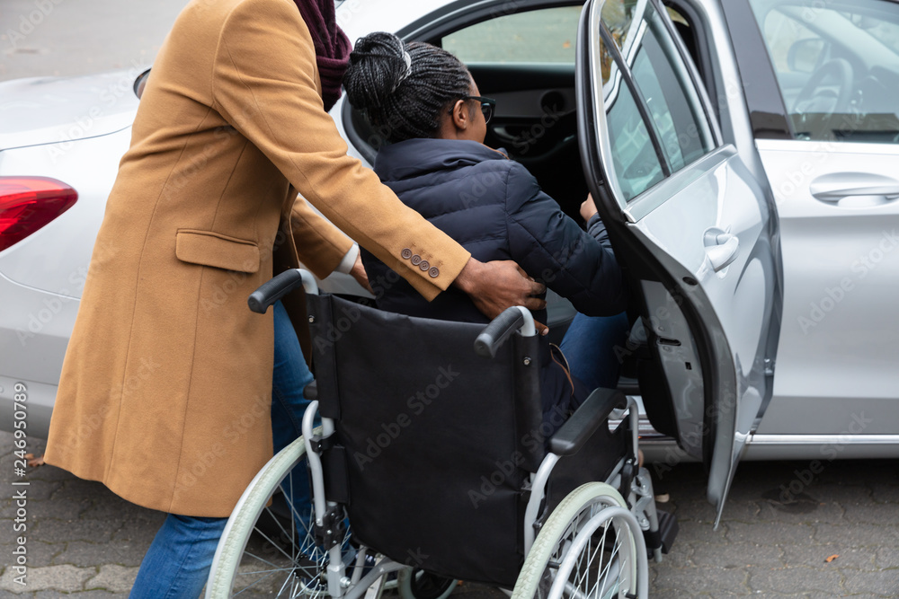 Man With Her Disabled Wife Moving Towards Car