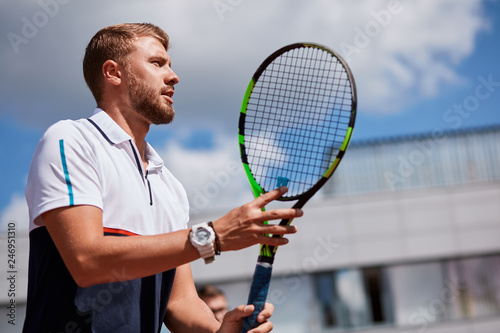 Tennis match which a serving player, keeping his eye on the ball. © alfa27