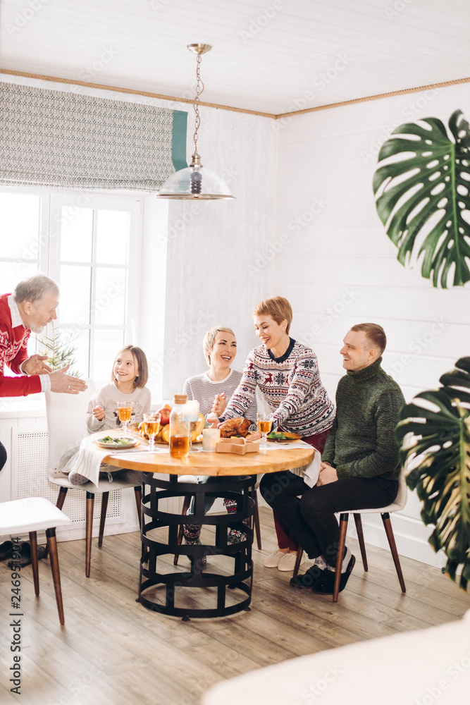 awesome hardworking woman has orginezed happy thanksgiving day. family is giving thanks during the dinner