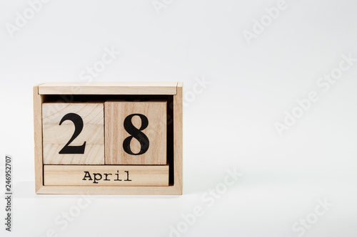 Wooden calendar April 28 on a white background