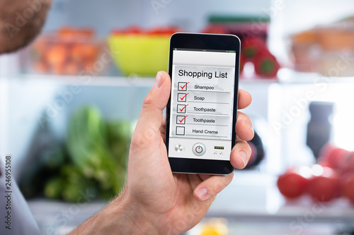 Human Hand Holding Mobilephone Checking Shopping List