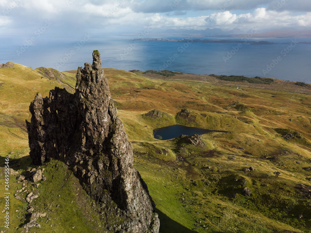 Aerial view of the Old Man of Storr with blue sky and clouds during a clear autumn day (Isle of Skye, Scotland, United Kingdom)