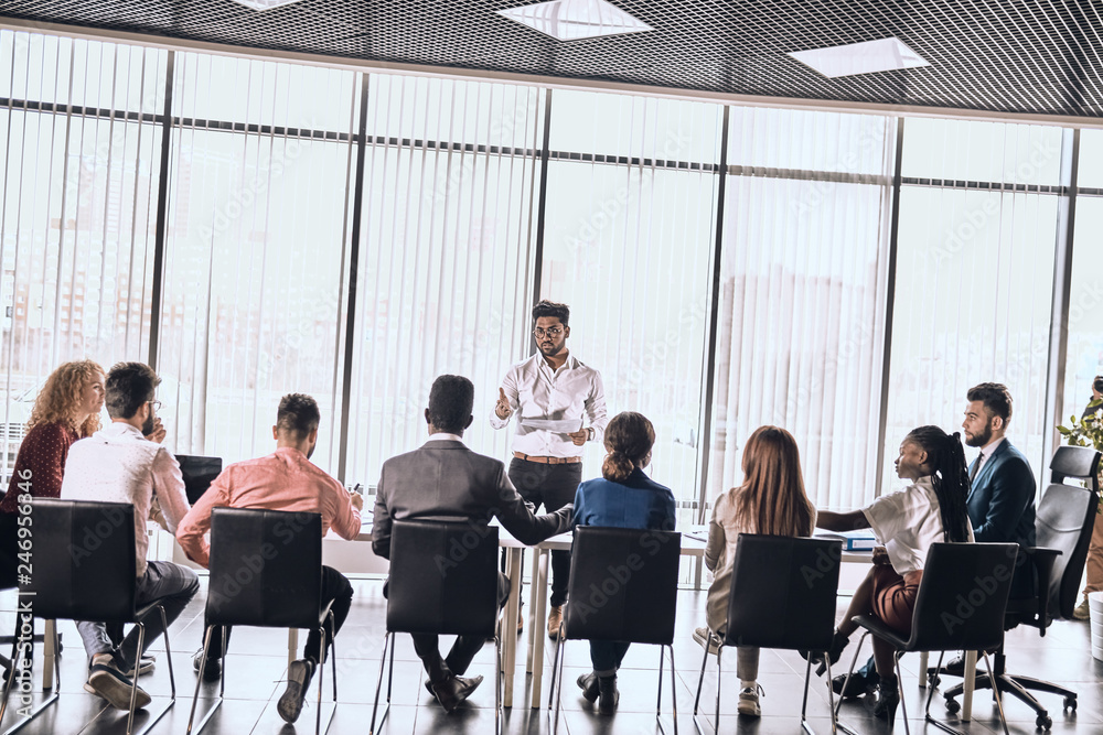 successful businessman giving talk at meeting. Entrepreneurship. young ambitious man teaching colleagues in conference hall. studing. man interviewing new workers. passing experience. advice successful businessman giving talk at meeting. Entrepreneurship. young ambitious man teaching colleagues in conference hall. studing. man interviewing new workers. passing experience. advice