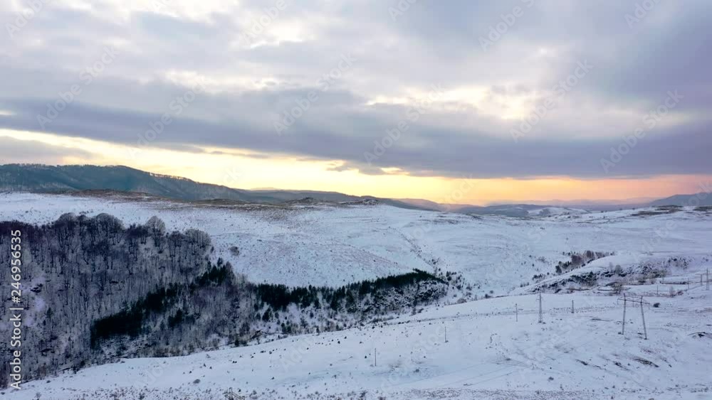 Aerial view of a gold sunrise over winter snow. Aerial view of a gold sunrise over winter snow.
