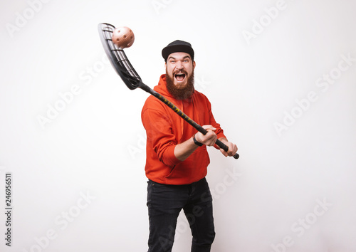 Photo of bearded man floorball, showing his skills, and enjoy it over white background