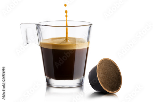 Black coffee in glass cup with coffee waffle and jumping drop on white background