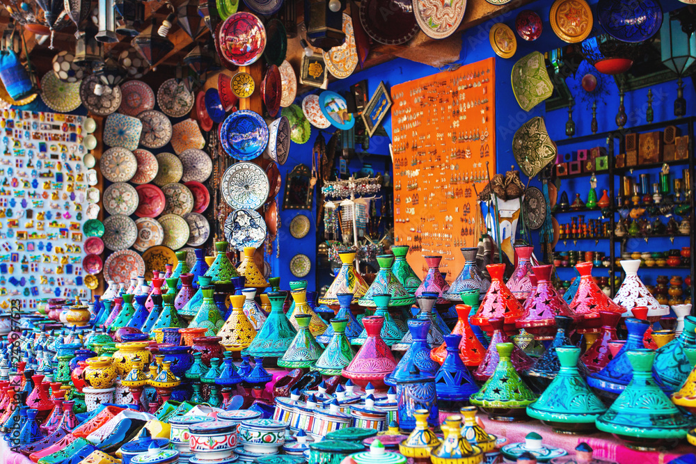 Colored Tajine, plates and pots out of clay on the market in Mor