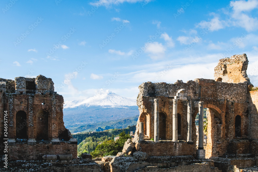Etna volcano behind the Roman Theater in Taormina Sicily