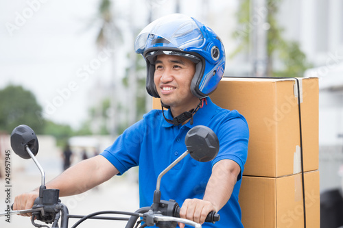 Delivery boy on motorcycle with trunk parcel box driving to fast in rush. Courier delivering order online. Express delivery within specified time by scooter concept