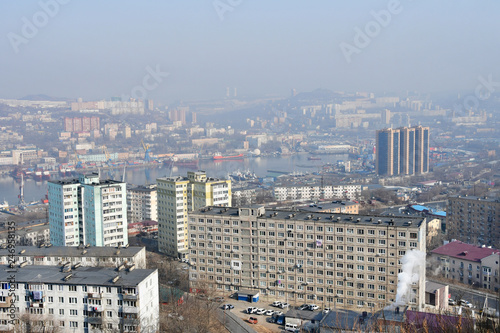 Russia. Winter Vladivostok in a haze. In the foreground street Okatovaya