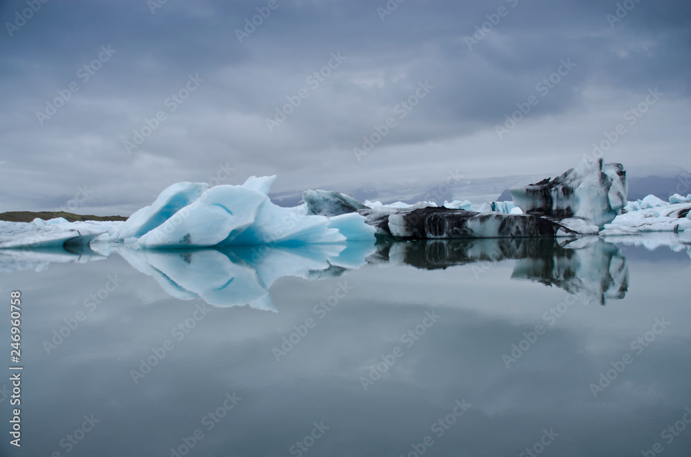 Blue and white ice with black volcanic ashes on Joekulsarlon glacier lagoon, Iceland