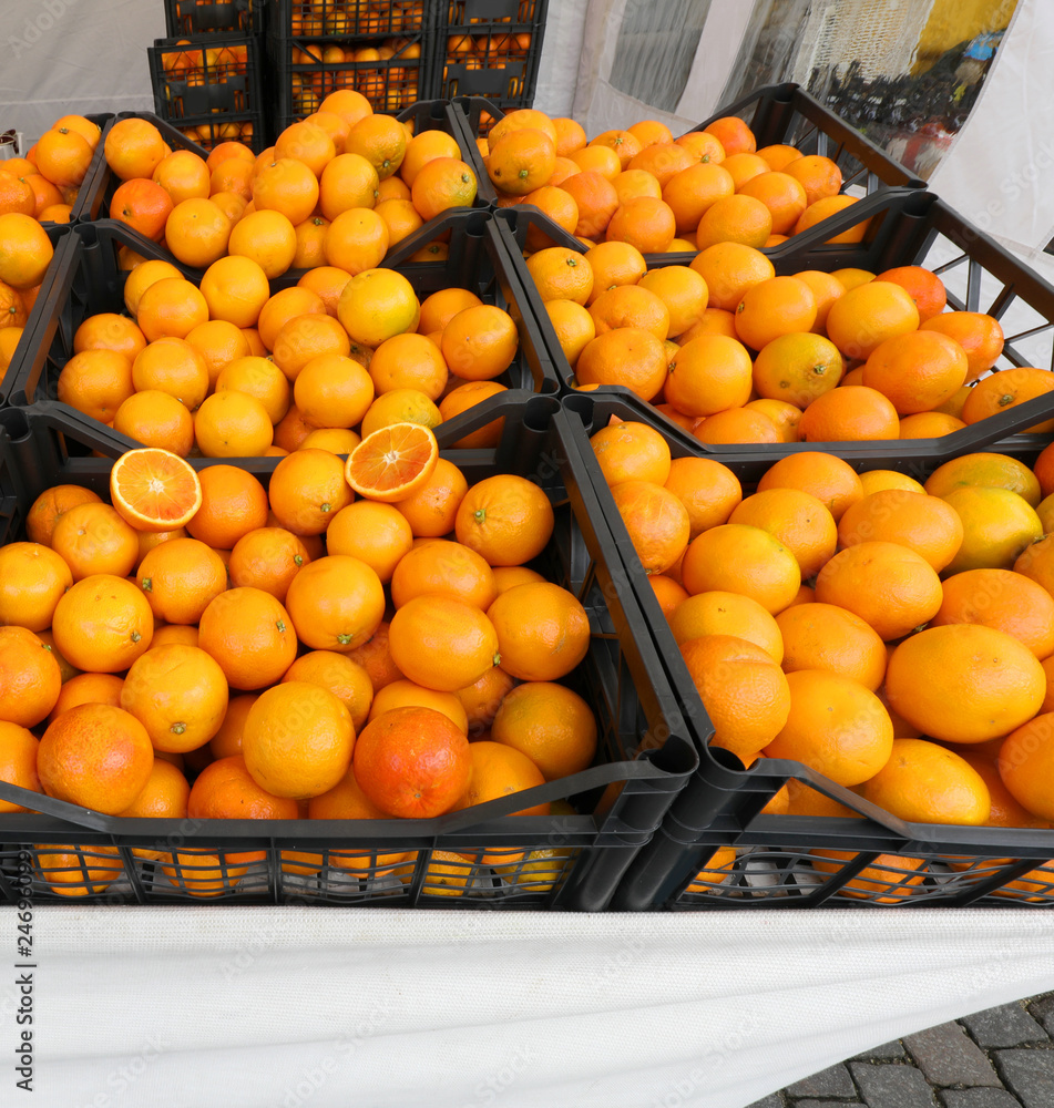 boxes full of fresh ripe oranges for sale at the local market